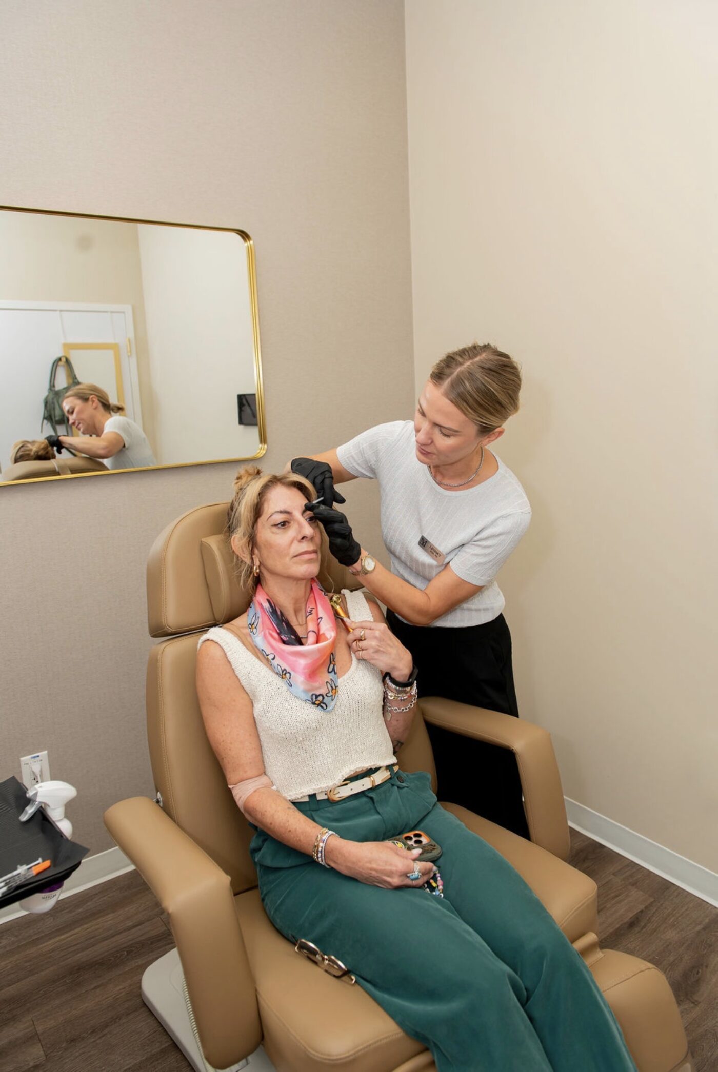 Lindsey Strelecki, BSN, RN, seated with a patient during a consultation at Manor in Fort Worth, mapping treatment areas before anything is injected